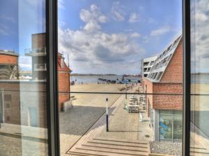 a view of a beach from a window at Ohlerich Speicher App_ 05 in Wismar