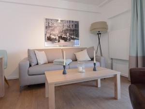a living room with a couch and a coffee table at Ohlerich Speicher App_ 41 in Wismar