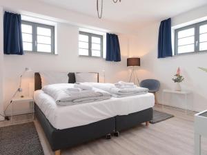 ヴィスマールにあるOhlerich Speicher App_ 29のベッドルーム1室(青いカーテン付きの大型ベッド1台付)