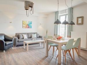 a living room with a table and a couch at Ohlerich Speicher App_ 30 in Wismar