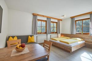 a room with a bed and a table with a dining room at Jaufenspitze Blasighof in Racines