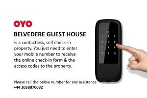 una mano apuntando a un mando a distancia con un mando a distancia en Belvedere Guest House, Great Yarmouth en Great Yarmouth