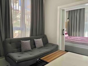 a living room with a couch and a window at Camelia 2 Beautiful 1+1 on Cleopatra in Alanya