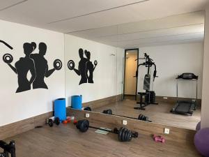 a room with a gym with weights and a mirror at Camelia 2 Beautiful 1+1 on Cleopatra in Alanya