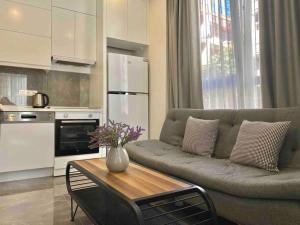 a living room with a couch and a table at Camelia 2 Beautiful 1+1 on Cleopatra in Alanya