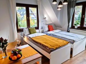 a small room with a bed and a table at Gościniec Skorusa in Kościelisko