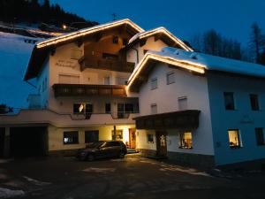 a building with a car parked in front of it at Apart Garni Wiesenhof in Kappl