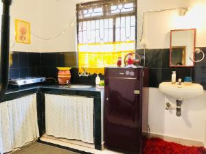 a small bathroom with a sink and a toilet at TheYelloMelloHouse 1BHK Wi-Fi AC Pet-Friendly Home in Mandrem