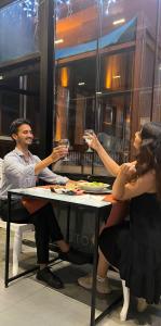 two people sitting at a table drinking wine at The Queen Airport Hotel in Arnavutköy