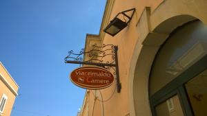 a sign for a restaurant on the side of a building at B&B Viaprimaldo Camere in Otranto