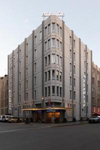 a large building on a street with cars parked in front at c-hotels Atlantic in Milan