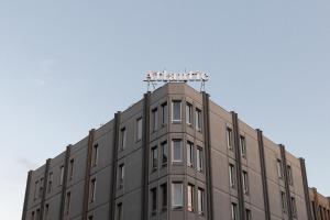 a building with a sign on the top of it at c-hotels Atlantic in Milan