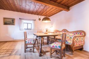 a dining room with a wooden table and chairs at Das Schusterhäusl - Urlaub im oberbayerischen Baudenkmal in Samerberg +57 photos