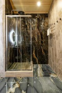 a shower with a glass door in a bathroom at Villa - ваш загородный дом in Borovoye