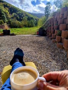 a person is holding a cup of coffee at l'écrin des biches in Sainte-Marie-aux-Mines