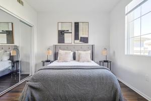 1 dormitorio blanco con 1 cama grande y 2 ventanas en Housy & Comfy 4BDR & 2BTH in Marina del Rey for 10 pax en Los Ángeles