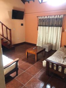 a living room with a bed and a table at Casa Dúplex Nueva Atlantis - Complejo San Norberto in Mar de Ajó