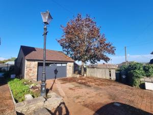 a house with a street light in the driveway at Rudgleigh Lodge by Cliftonvalley Apartments in Bristol