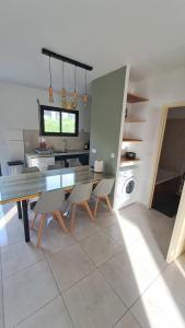 a kitchen with a table and chairs in a kitchen at La Kay Fyfy in Saint-Pierre