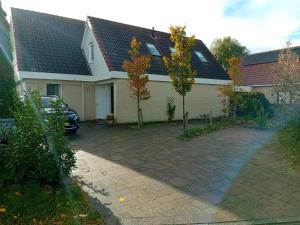 a house with a car parked in a driveway at Oudaen 36 in Lelystad