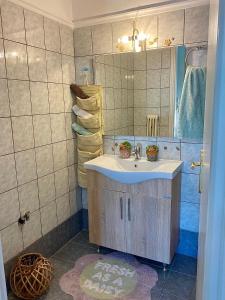 a bathroom with a sink and a mirror at top8 view in Tríkala +33 photos