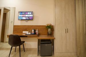 a desk in a room with a chair and a table at The Triana in Varanasi +40 photos