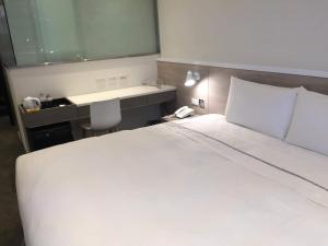 Letto o letti in una camera di CityInn Hotel Plus- Fuxing North Road Branch