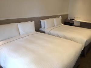 Letto o letti in una camera di CityInn Hotel Plus- Fuxing North Road Branch