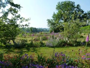 a garden with flowers and trees in a field at The Hall in Penrith