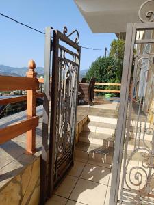 a gate on a balcony with a view of the mountains at Zorbas House in Dhesfína