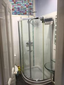 a shower with a glass door in a bathroom at Bellevue Bute, Luxury 2 bedroom sea view flat in Rothesay