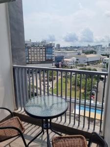 een balkon met een tafel en stoelen en uitzicht op de stad bij HarbourBay Residence. Batam. Studio. 1min to Ferry in Jodoh