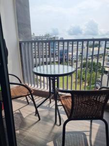 a balcony with a table and two chairs and a table at HarbourBay Residence. Batam. Studio. 1min to Ferry in Jodoh