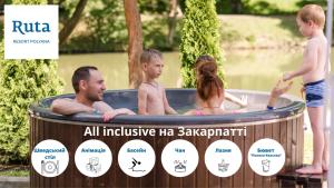 a man and two children playing in a hot tub at Ruta Resort Polyana in Polyana