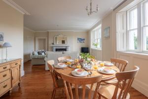 a kitchen and dining room with a table and chairs at Little Oak in Holbeton