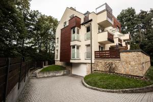 a building with a fence in front of it at Apartament przy bulwarach w Straconce in Bielsko-Biala