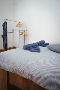 een bed met een blauwe deken erop bij BM Apartman in Gornji Milanovac