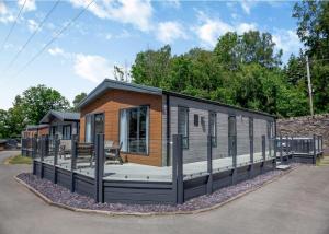 a tiny house with a large deck at C03 - The Faraday in Bangor