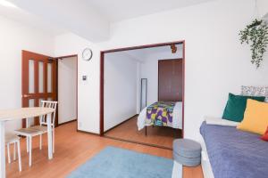 a room with a couch and a table and a bed at Grande es TENJIN in Fukuoka