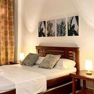 a bedroom with a bed with two lamps on it at JORA Studio Apartment 1-B in Dagupan