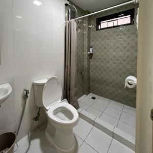 a bathroom with a toilet and a shower and a sink at JORA Studio Apartment 1-B in Dagupan +35 photos