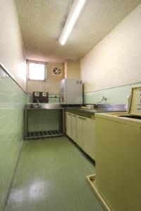 an empty kitchen with green flooring in a room at Hotel Wako in Osaka