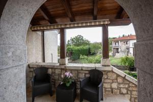 a patio with two chairs and a table with flowers at #914 Home - Irpinia in Nusco