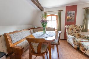 a living room with a table and a couch at Ferienhaus Helga in Absberg