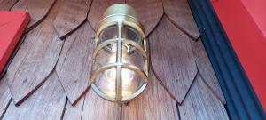 a brass door knocker on a wooden door at Bledford Chiloé in Castro