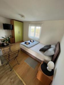 a bedroom with a large bed and a couch at Budget Friendly in Požega