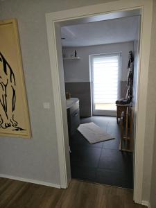 a bathroom with a sink and a toilet and a window at Haus SauerlandLiebe in Schmallenberg