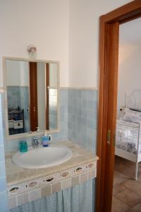 ein Bad mit einem Waschbecken und einem Spiegel in der Unterkunft Bella Bari in Bari