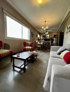 a living room with two couches and a table at Mirador Yerba Buena in Yerba Buena