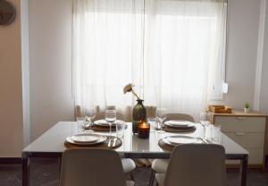 a dining room table with chairs and a vase on it at Gtrip P Faliro Coastal Comfort 2F in Athens